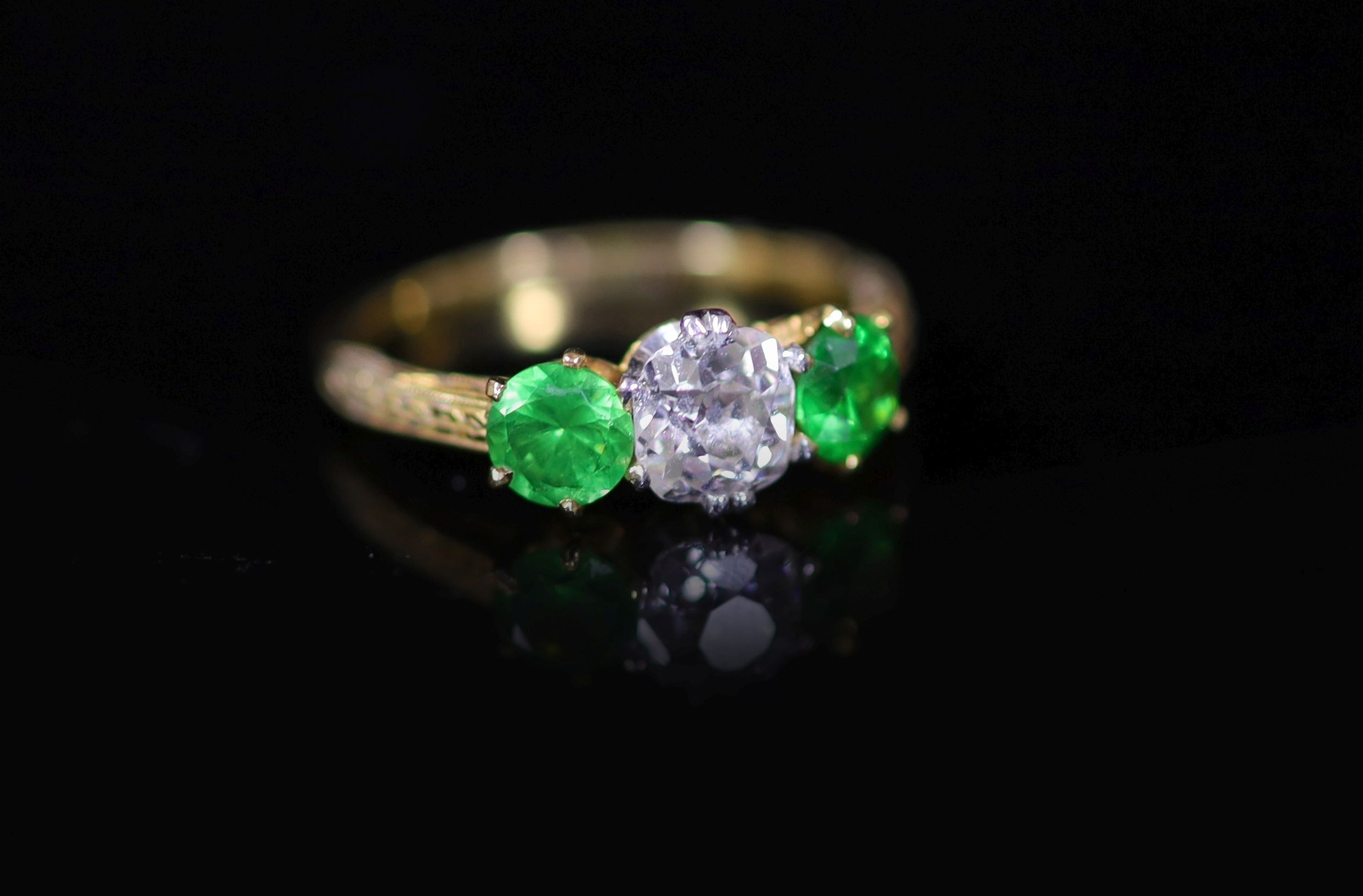 A Tiffany & Co gold, single stone diamond and two stone demantoid garnet set ring